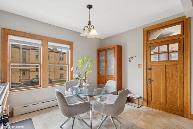 dining area featuring a baseboard radiator and a chandelier
