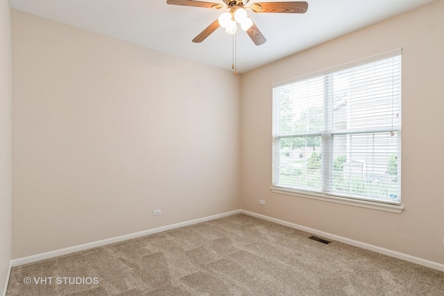 1520 Mansfield Dr, Aurora, IL 60502 - unfurnished room with plenty of natural light, light colored carpet, and ceiling fan