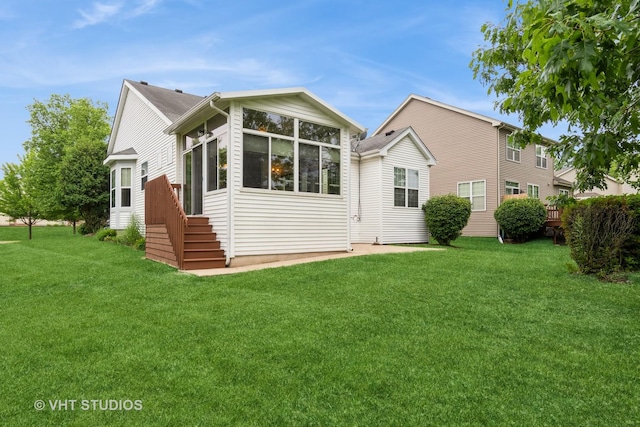 1520 Mansfield Dr, Aurora, IL 60502 - rear view of house featuring a lawn and a sunroom