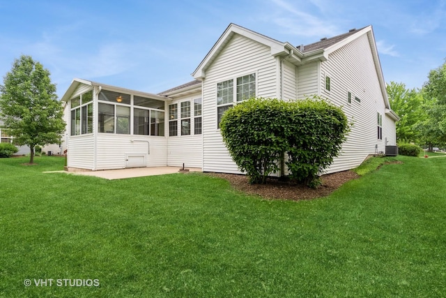 1520 Mansfield Dr, Aurora, IL 60502 - back of house with a patio area, a sunroom, and a lawn
