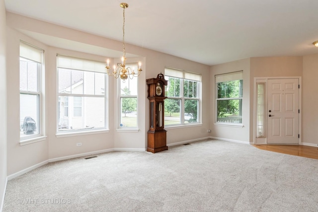 1520 Mansfield Dr, Aurora, IL 60502 - unfurnished dining area featuring carpet floors and a chandelier