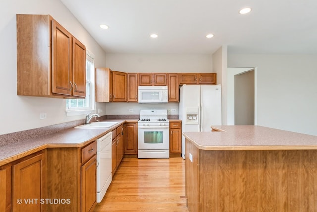 1520 Mansfield Dr, Aurora, IL 60502 - kitchen featuring white appliances, light wood-style floors, brown cabinetry, recessed lighting, and light countertops