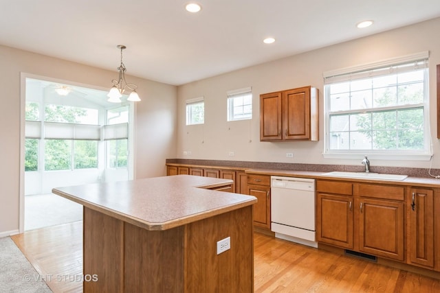 1520 Mansfield Dr, Aurora, IL 60502 - kitchen with white dishwasher, brown cabinets, a center island, light wood-style floors, and recessed lighting