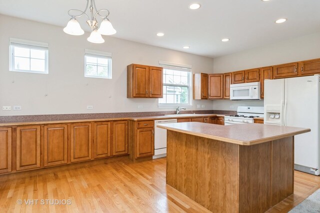 1520 Mansfield Dr, Aurora, IL 60502 - kitchen featuring white appliances, brown cabinets, plenty of natural light, recessed lighting, and a chandelier