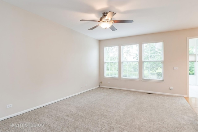 1520 Mansfield Dr, Aurora, IL 60502 - empty room with ceiling fan, healthy amount of natural light, and light carpet