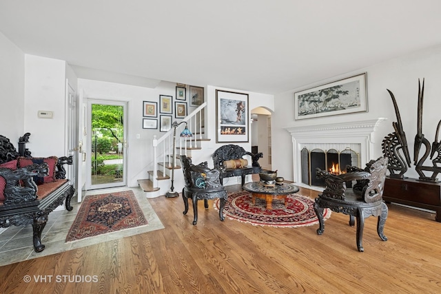 145 W Lake Shore Dr, Tower Lakes, IL 60010 - living area with arched walkways, wood finished floors, a fireplace, and stairway