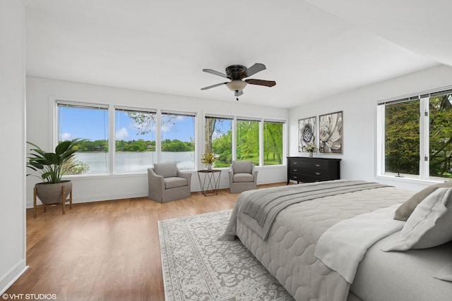 145 W Lake Shore Dr, Tower Lakes, IL 60010 - bedroom with multiple windows, light wood-style floors, baseboards, and a water view