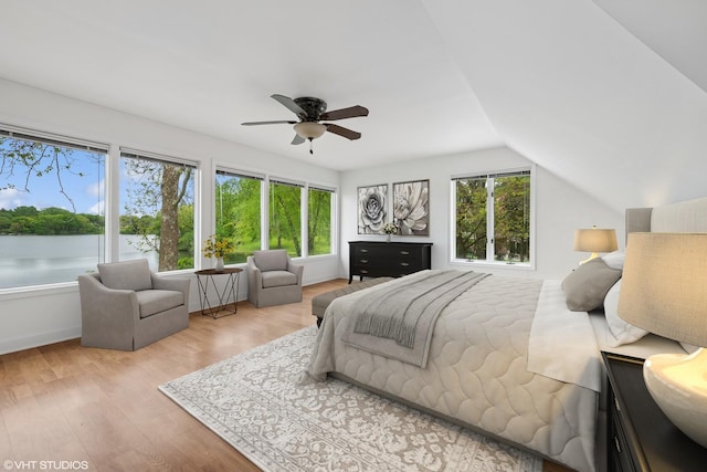 145 W Lake Shore Dr, Tower Lakes, IL 60010 - bedroom featuring multiple windows, wood finished floors, a water view, vaulted ceiling, and a ceiling fan