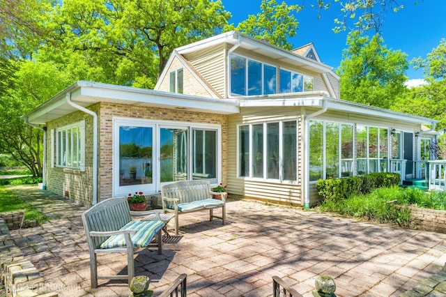 145 W Lake Shore Dr, Tower Lakes, IL 60010 - rear view of property with a sunroom, a patio, and brick siding