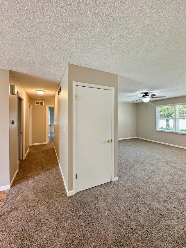 5411 S Brookstone Dr, Rochelle, IL 61068 - corridor featuring carpet, a textured ceiling, and baseboards