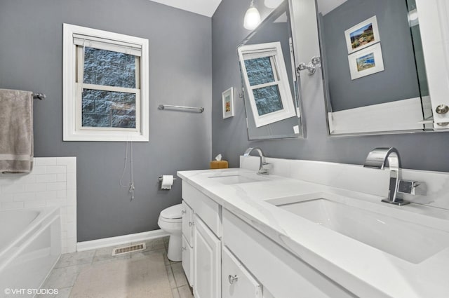 2842 N Southport Ave Unit 2, Chicago, IL 60657 - full bathroom with baseboards, toilet, double vanity, and a bath