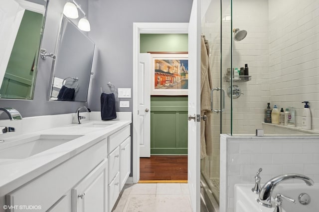 2842 N Southport Ave Unit 2, Chicago, IL 60657 - bathroom with a stall shower, a bath, double vanity, and tile patterned flooring
