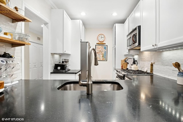2842 N Southport Ave Unit 2, Chicago, IL 60657 - kitchen with stainless steel microwave, a sink, decorative backsplash, open shelves, and white cabinets