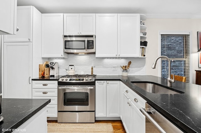 2842 N Southport Ave Unit 2, Chicago, IL 60657 - kitchen with stainless steel appliances, a sink, open shelves, ornamental molding, and white cabinets