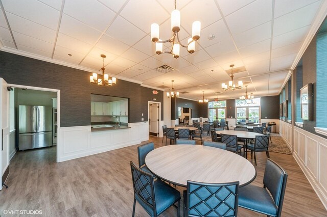 1200 Ardmoor Dr, Crystal Lake, IL 60012 - dining area featuring a chandelier, wood finished floors, a decorative wall, wainscoting, and a paneled ceiling