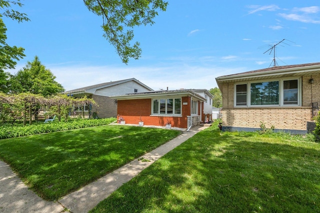 view of front facade featuring a front yard and brick siding