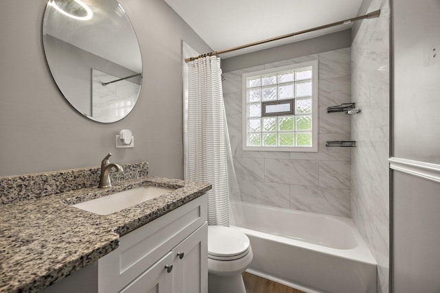 bathroom featuring toilet, shower / tub combo with curtain, vanity, and wood finished floors