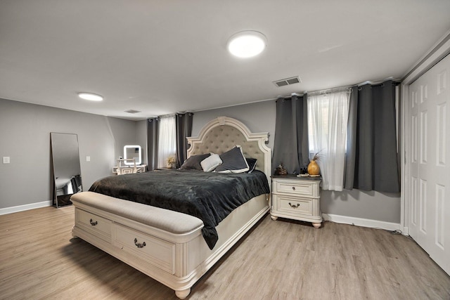bedroom with light wood-style floors and baseboards