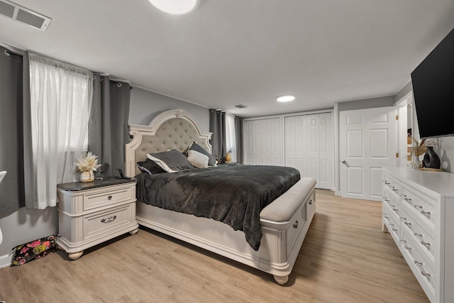 bedroom featuring light wood finished floors and a closet