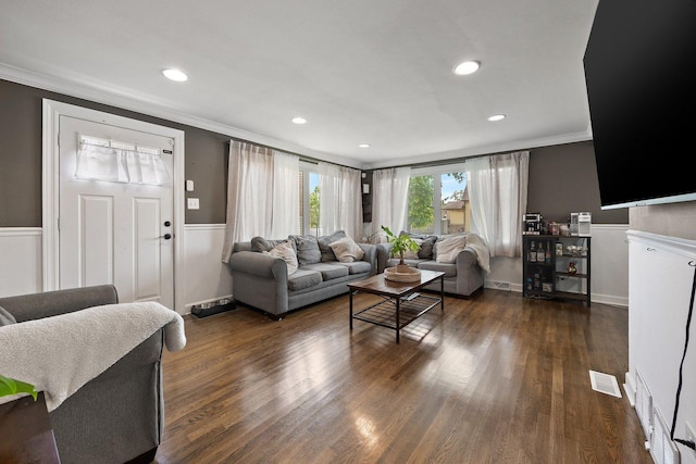 living area featuring crown molding, a wainscoted wall, dark wood finished floors, and recessed lighting