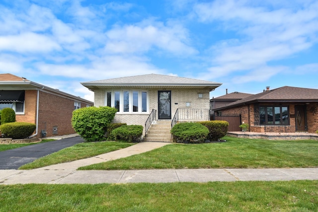 430 Marquette Ave, Calumet City, IL 60409 - bungalow featuring brick siding and a front lawn