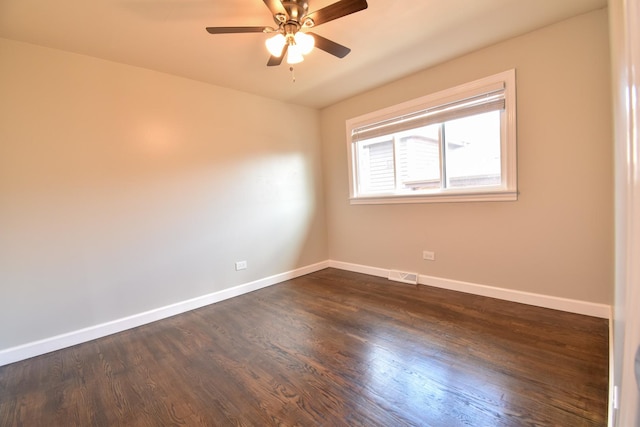 430 Marquette Ave, Calumet City, IL 60409 - spare room featuring dark wood-style floors, baseboards, and a ceiling fan