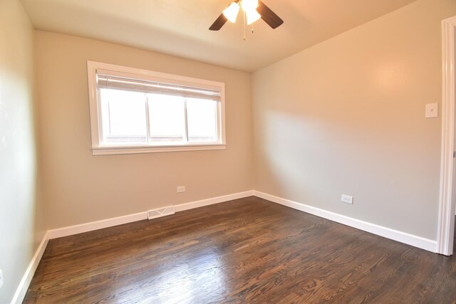 430 Marquette Ave, Calumet City, IL 60409 - spare room featuring dark wood-style floors, a ceiling fan, and baseboards