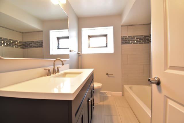 430 Marquette Ave, Calumet City, IL 60409 - bathroom featuring toilet, vanity, tile patterned flooring, and baseboards
