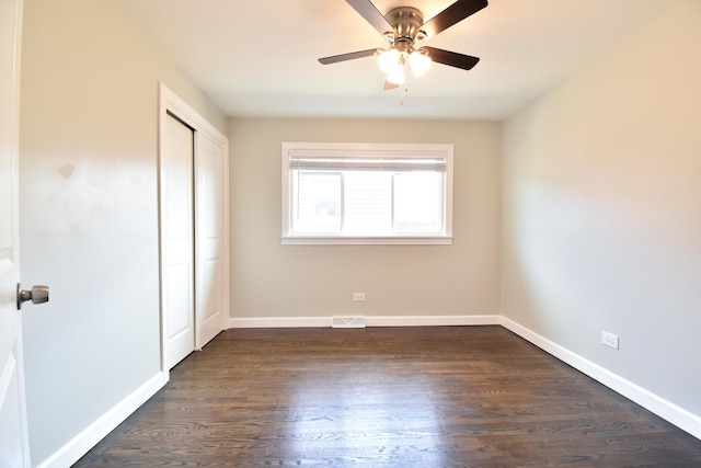 430 Marquette Ave, Calumet City, IL 60409 - unfurnished bedroom with a closet, baseboards, dark wood-type flooring, and a ceiling fan