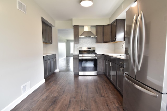 430 Marquette Ave, Calumet City, IL 60409 - kitchen featuring stainless steel appliances, wall chimney exhaust hood, light countertops, dark wood finished floors, and baseboards