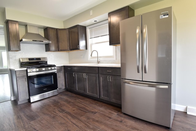 430 Marquette Ave, Calumet City, IL 60409 - kitchen featuring stainless steel appliances, wall chimney range hood, a sink, and dark wood-style flooring