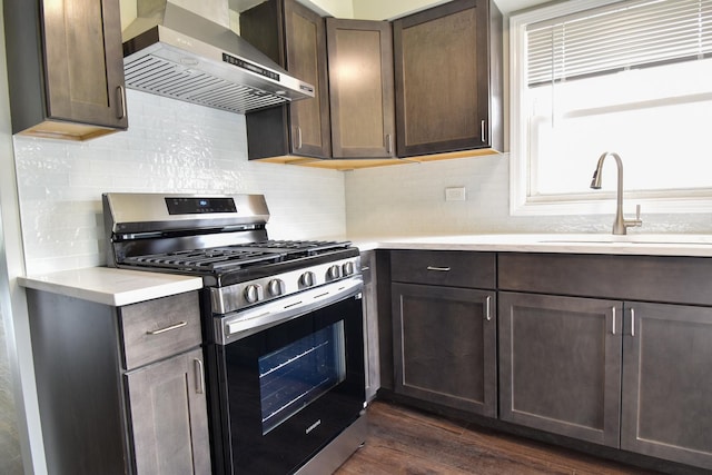 430 Marquette Ave, Calumet City, IL 60409 - kitchen with stainless steel gas stove, wall chimney exhaust hood, a sink, and light countertops
