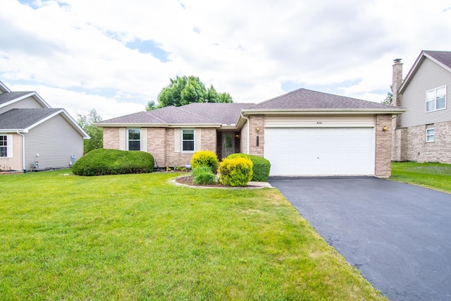 ranch-style house featuring brick siding, asphalt driveway, an attached garage, a front lawn, and roof with shingles