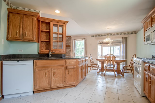 kitchen with white appliances, a sink, open shelves, light tile patterned floors, and pendant lighting