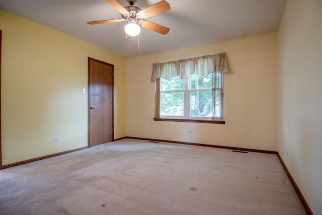 unfurnished room featuring carpet flooring, baseboards, and ceiling fan