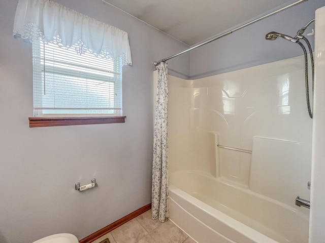 bathroom featuring tile patterned floors, shower / bath combination with curtain, and baseboards