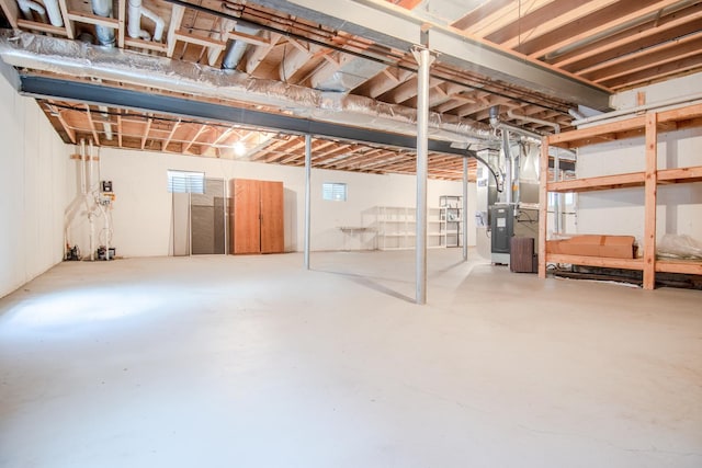 unfinished below grade area featuring heating unit