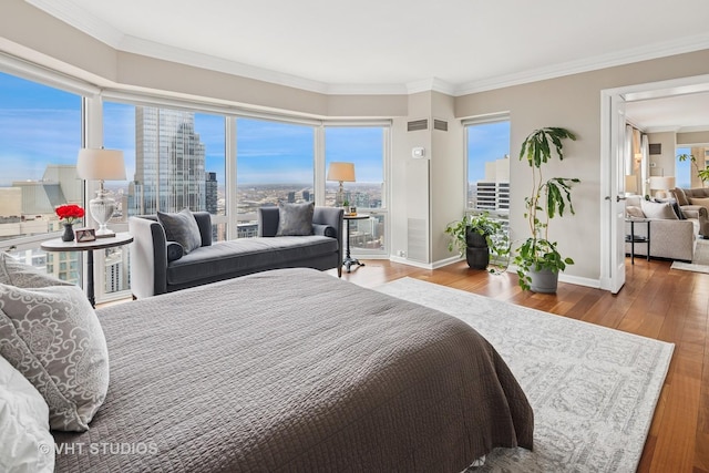 100 E Huron St Unit 4801, Chicago, IL 60611 - bedroom featuring wood finished floors, a city view, baseboards, and ornamental molding