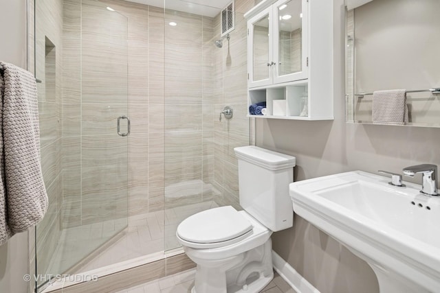 100 E Huron St Unit 4801, Chicago, IL 60611 - full bath featuring toilet, a sink, a shower stall, tile patterned floors, and recessed lighting