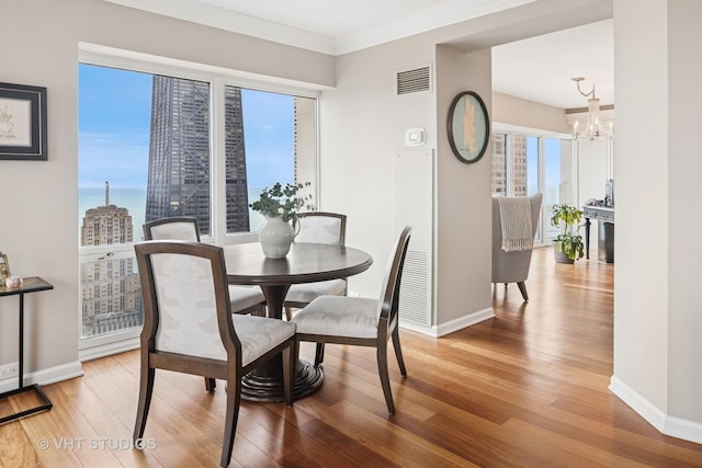 100 E Huron St Unit 4801, Chicago, IL 60611 - dining space featuring baseboards, wood finished floors, and ornamental molding