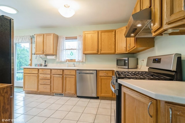 91 Fletcher Dr, Des Plaines, IL 60016 - kitchen with appliances with stainless steel finishes, under cabinet range hood, light tile patterned floors, and light countertops