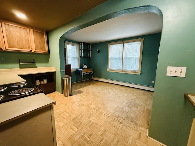 204 N Center St, Colfax, IL 61728 - kitchen with arched walkways, a baseboard radiator, light countertops, and baseboards