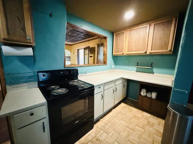 204 N Center St, Colfax, IL 61728 - kitchen with black range with electric cooktop and light countertops