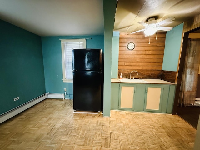 204 N Center St, Colfax, IL 61728 - kitchen featuring freestanding refrigerator, wood walls, a sink, a ceiling fan, and light countertops
