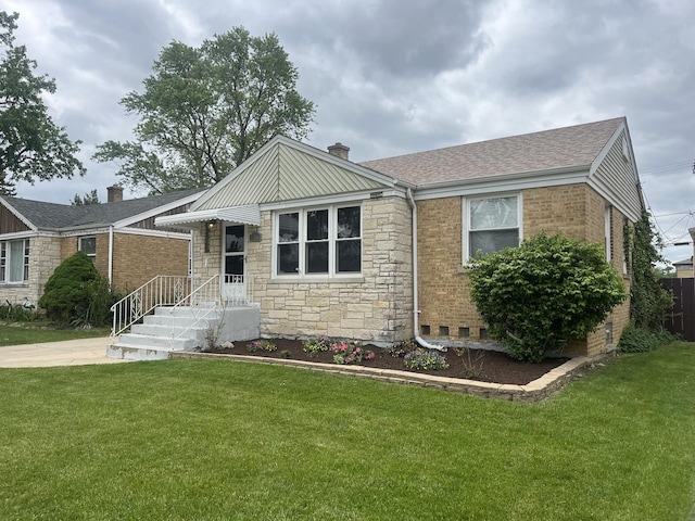 2256 S 15th Ave, North Riverside, IL 60546 - view of front facade featuring a front yard, stone siding, a chimney, and roof with shingles