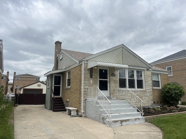 2256 S 15th Ave, North Riverside, IL 60546 - bungalow-style home with a chimney, stone siding, a garage, and an outdoor structure