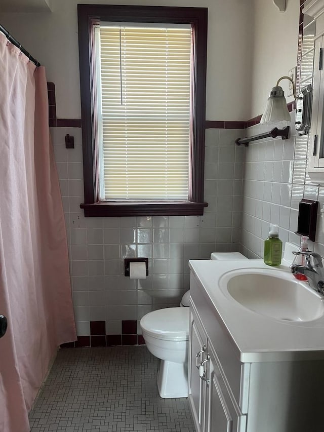 2256 S 15th Ave, North Riverside, IL 60546 - full bath with tile walls, toilet, vanity, a shower with shower curtain, and tile patterned flooring