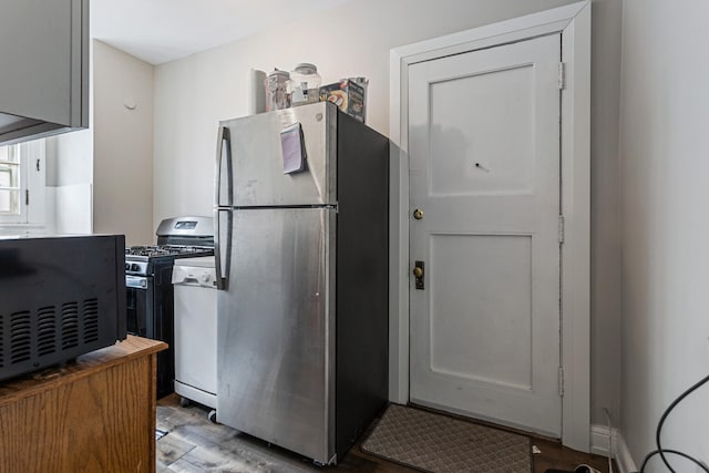 408 N Prairie St Unit 3, Champaign, IL 61820 - kitchen with freestanding refrigerator, gas stove, wood finished floors, and white dishwasher