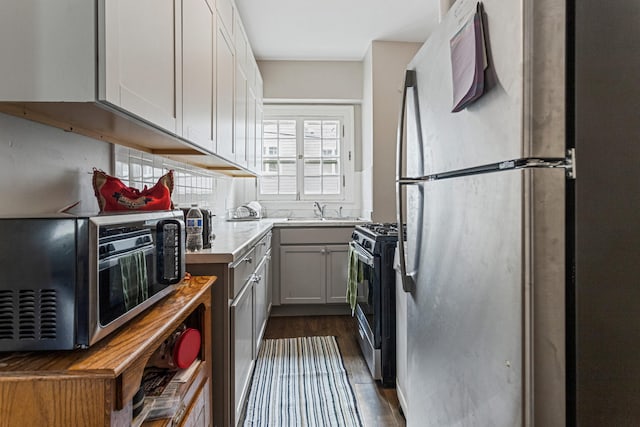 408 N Prairie St Unit 3, Champaign, IL 61820 - kitchen featuring appliances with stainless steel finishes, light countertops, dark wood-type flooring, and a sink
