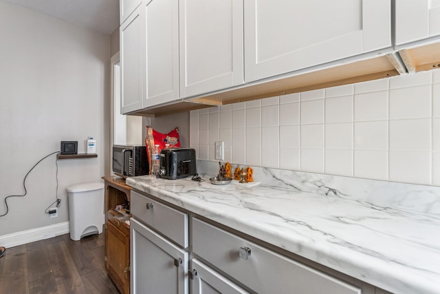 408 N Prairie St Unit 3, Champaign, IL 61820 - kitchen featuring baseboards, dark wood-style floors, backsplash, stainless steel microwave, and light stone countertops